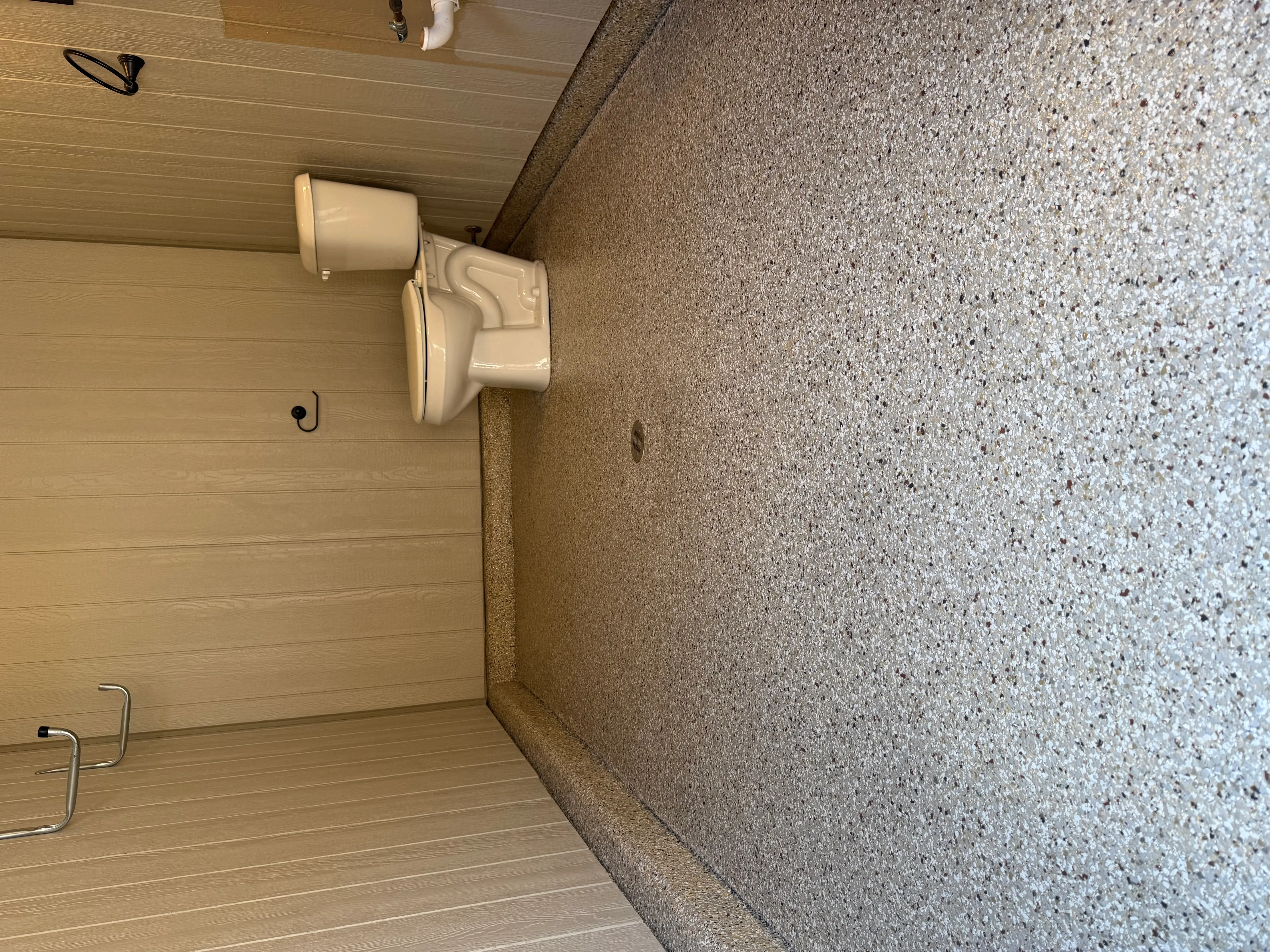 Light gray speckled epoxy floor with aggregate finish and clean edge detail